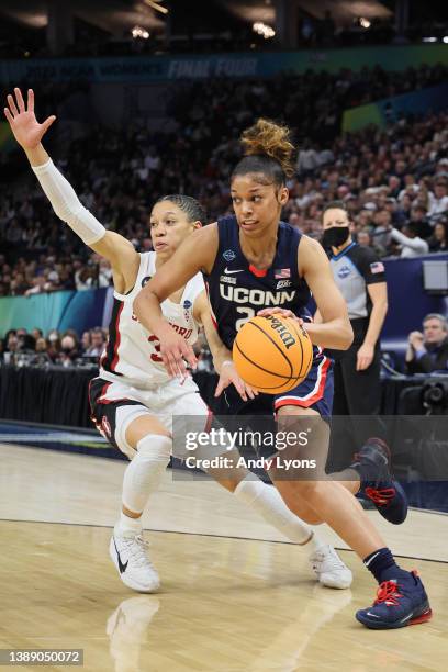 Evina Westbrook of the UConn Huskies drives the ball passed Anna Wilson of the Stanford Cardinal in the first quarter during the 2022 NCAA Women's...