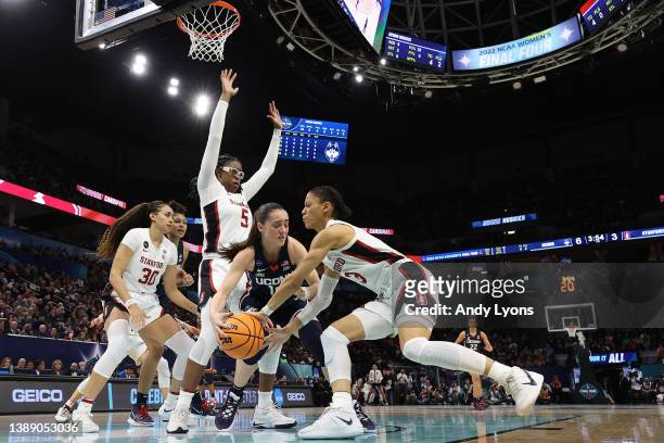 Nika Muhl of the UConn Huskies and Anna Wilson of the Stanford Cardinal battle for the ball in the first half during the 2022 NCAA Women's Final Four...