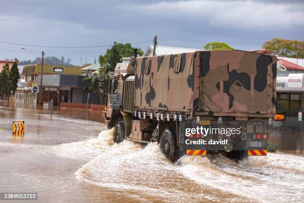 army truck driving through the flooded streets of lismore - army stock pictures, royalty-free photos & images