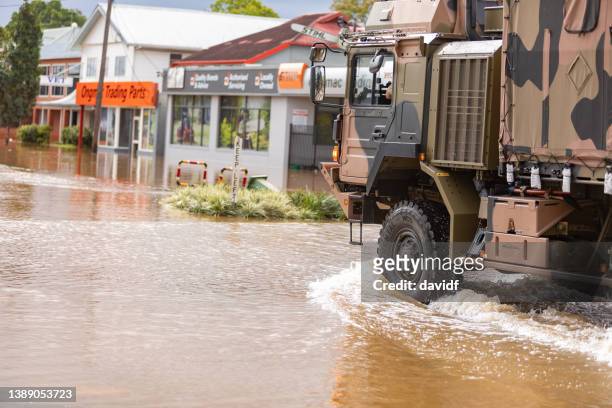 army truck driving through the flooded streets of lismore - australian army stock pictures, royalty-free photos & images