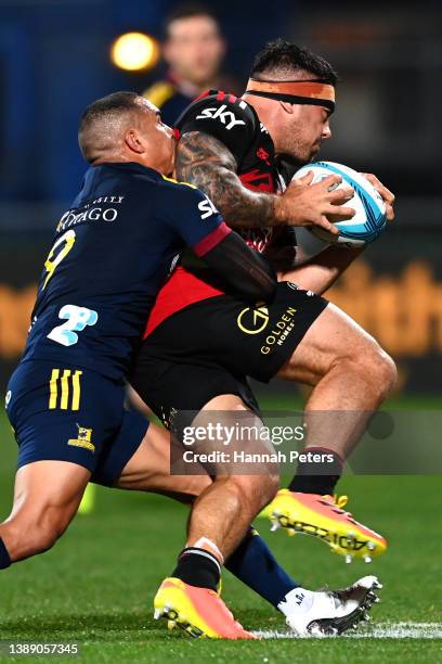 Aaron Smith of the Highlanders tackles Codie Taylor of the Crusaders during the round seven Super Rugby Pacific match between the Crusaders and the...