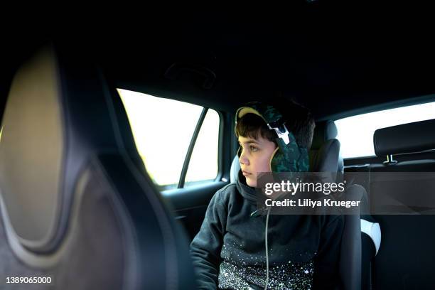 boy in headphones traveling in a car. - motorheadphones stock pictures, royalty-free photos & images