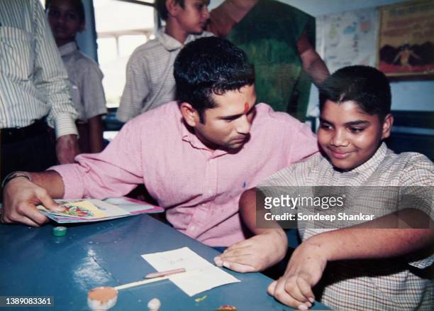 Cricketer Sachin Tendulkar with children with physical disabilities at Akshay Pratisthan in New Delhi.