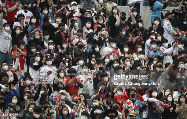 Fans cheer during the Korean Baseball Organization League opening game between Kiwoom Heroes and Lotte Giants at Gocheok Skydome on April 02, 2022 in...