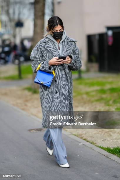 Guest wears a gray hoodie zipper sweater, a dark and pale gray zebra print pattern long fluffy coat, a royal blue electric varnished leather with...