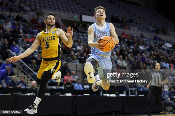 Jake Rhode of the Elmhurst Bluejays drives past Buzz Anthony of the Randolph-Macon Yellow Jackets during the Division III Men's Basketball...