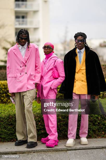 Guest wears sunglasses, silver and orange hair rings, a white shirt, a pale pink oversized blazer jacket with a white pearls necklace, khaki large...