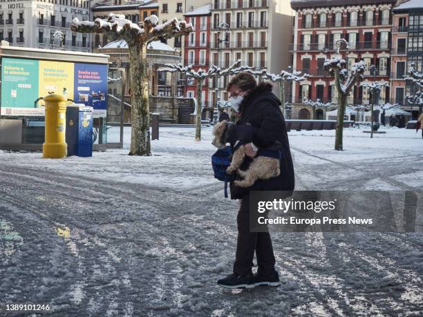 Woman with a dog walks cautiously through the snowy Plaza del Castillo, on 02 April, 2022 in Pamplona, Navarra, Spain. In the early hours of Saturday...