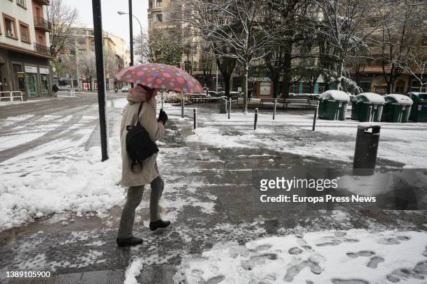 Woman with an umbrella walks along a snowy street on April 2 in Pamplona, Navarra, Spain. In the early hours of Saturday, April 2, snow has returned...