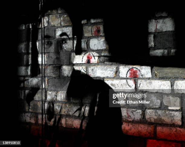 Video is projected on a piece of the brick wall from the February 14 St. Valentine's Day Massacre as part of a display at The Mob Museum February 13,...