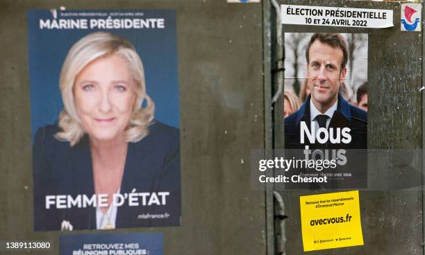 An official campaign poster of Marine Le Pen, leader of the far-right Rassemblement national and an official campaign poster of President Emmanuel...