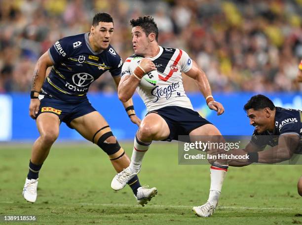 Nat Butcher of the Roosters is tackled by Jason Taumalolo of the Cowboys during the round four NRL match between the North Queensland Cowboys and the...