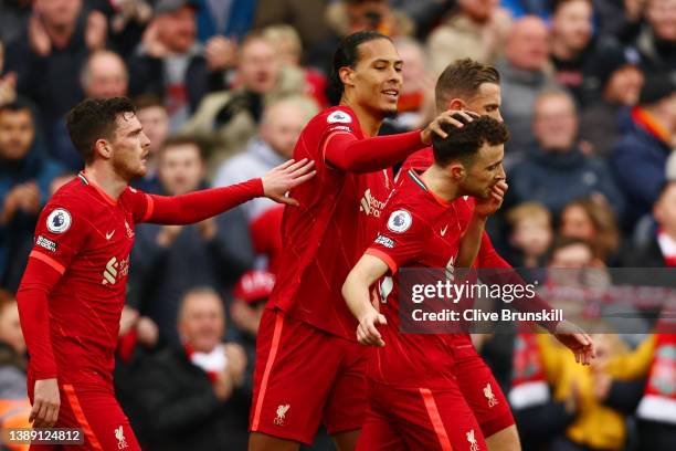 Diogo Jota of Liverpool celebrates with teammates Andrew Robertson, Virgil van Dijk and Jordan Henderson after scoring their team's first goal during...