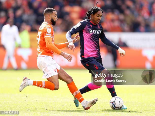 Djed Spence of Nottingham Forest battles for possession with CJ Hamilton of Blackpool during the Sky Bet Championship match between Blackpool and...