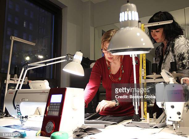 Local designer Jackie Fraser-Swan discusses details on a design with her head seamstress, Lana Denis, at Swan's Newbury Street atelier on Feb. 2,...