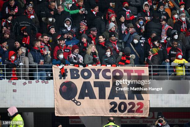 Fans of Freiburg display a banner about boycotting the FIFA World Cup 2022 in Qatar prior to the Bundesliga match between Sport-Club Freiburg and FC...