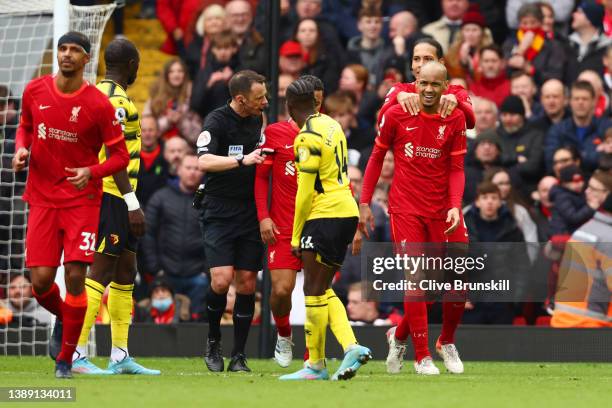 Fabinho of Liverpool celebrates with teammates after scoring their team's second goal from the penalty spot during the Premier League match between...