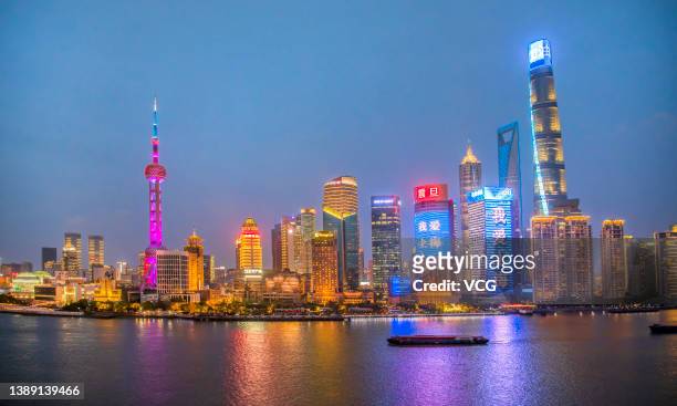 Illuminated skyscrapers stand at the Pudong Lujiazui Financial District after Shanghai imposed a citywide lockdown to halt the spread of COVID-19...