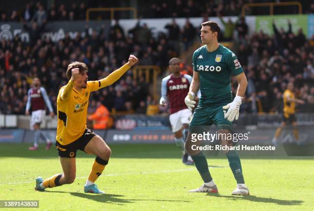 Francisco Trincao of Wolverhampton Wanderers celebrates an own goal scored by Ashley Young of Aston Villa during the Premier League match between...