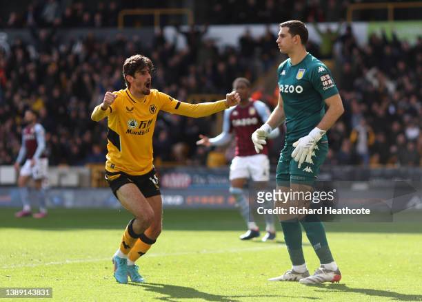 Francisco Trincao of Wolverhampton Wanderers celebrates an own goal scored by Ashley Young of Aston Villa during the Premier League match between...