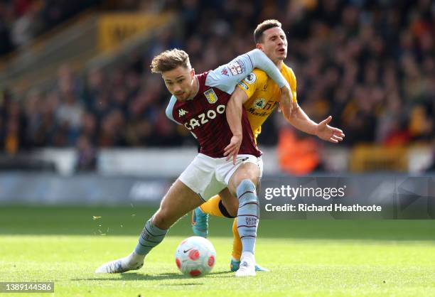 Matty Cash of Aston Villa battles for possession with Daniel Podence of Wolverhampton Wanderers during the Premier League match between Wolverhampton...