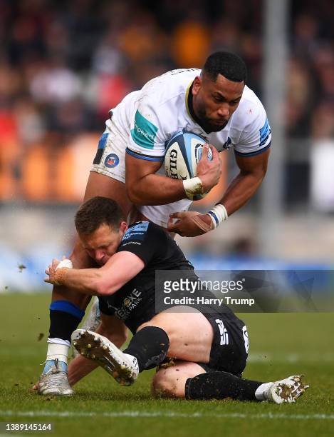 Joe Cokanasiga of Bath Rugby is tackled by Joe Simmonds of Exeter Chiefs during the Gallagher Premiership Rugby match between Exeter Chiefs and Bath...