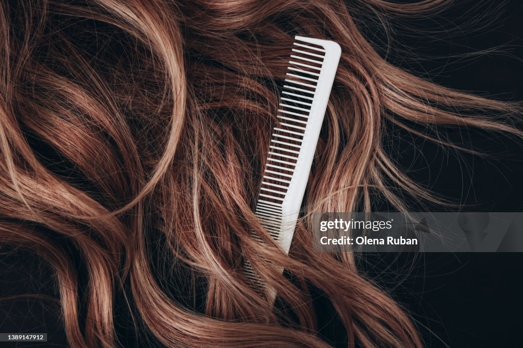 Haircomb hairbrushing brown hair.