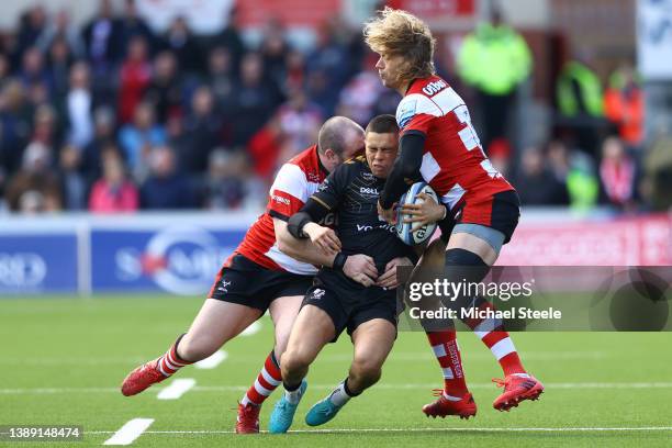 Jacob Umaga of Wasps is tackled by Fraser Balmain and Billy Twelvetrees during the Gallagher Premiership Rugby match between Gloucester Rugby and...