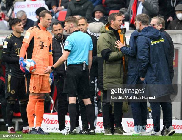 Match referee Christian Dingert speaks with Manuel Neuer of FC Bayern Muenchen and Hasan Salihamidzic, Sporting Director of FC Bayern Muenchen during...