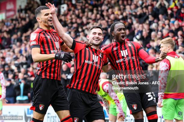 Lewis Cook of Bournemouth celebrates with team-mates Dominic Solanke and Jordan Zemura after he scores a goal to make it 2-1 during the Sky Bet...