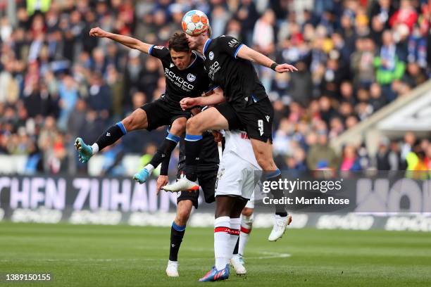 Fabian Klos clashes with team mate Alessandro Schoepf of DSC Arminia Bielefeld in the air during the Bundesliga match between DSC Arminia Bielefeld...