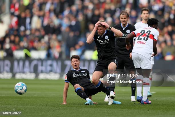 Fabian Klos after clashing with team mate Alessandro Schoepf of DSC Arminia Bielefeld in the air during the Bundesliga match between DSC Arminia...