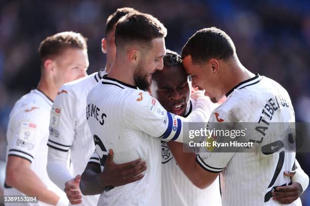 Michael Obafemi of Swansea City celebrates scoring their side's fourth goal with Matt Grimes and Joel Latibeaudiere during the Sky Bet Championship...