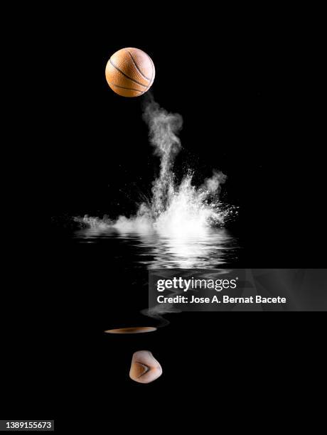 impact and rebound of a ball of basketball on a surface of land and powder reflected in the water. - ballon rebond stock pictures, royalty-free photos & images