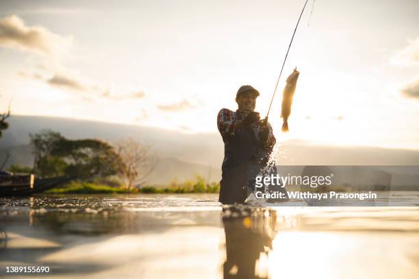 young man flyfishing at sunrise - wading boots stock pictures, royalty-free photos & images