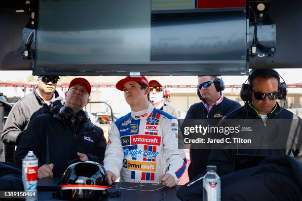 Harrison Burton, driver of the Motorcraft/Quick Lane Ford, and crew work on the grid qualifying for the NASCAR Cup Series Toyota Owners 400 at...