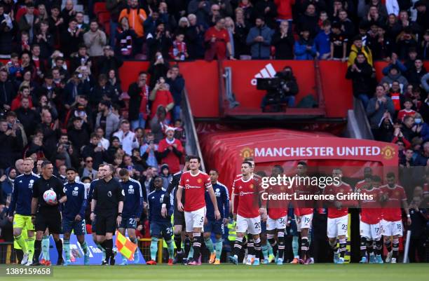 Harry Maguire of Manchester United leads their side out onto the pitch prior to the Premier League match between Manchester United and Leicester City...