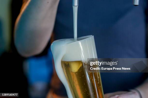 Waiter throws a craft beer in one of the bars participating in 'Artesana Week Lavapies', in Argumosa street, on 02 April, 2022 in Madrid, Spain. In...