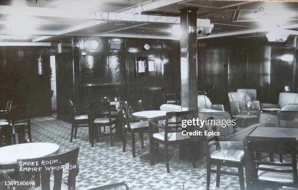 Postcard from 1951 depicting the furniture of the smoke room onboard the Empire Windrush, a passenger liner and cruise ship that was launched in 1930...