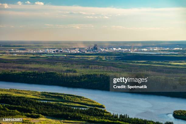 aerial petrochemical oil refinery along the athabasca river - fort mcmurray stock pictures, royalty-free photos & images