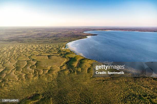 aerial landscape view of remote lake mcclelland alberta - global climate change stock pictures, royalty-free photos & images