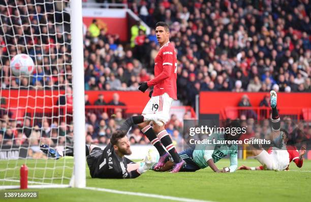 Kelechi Iheanacho of Leicester City scores their side's first goal past Raphael Varane and David De Gea of Manchester United during the Premier...