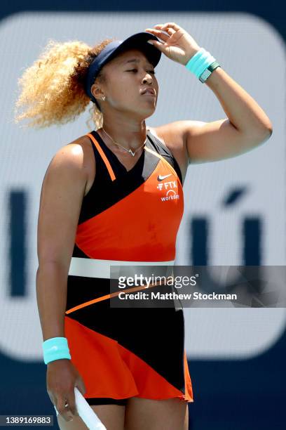 Naomi Osaka of Japan adjusts her cap while playing Iga Swiatek of Poland during the women's final of the Miami Open at Hard Rock Stadium on April 02,...