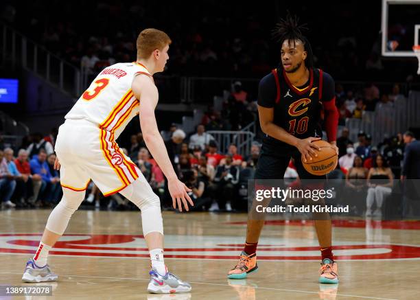 Darius Garland of the Cleveland Cavaliers looks to pass as he is guarded by Kevin Huerter of the Atlanta Hawks during the first half at State Farm...