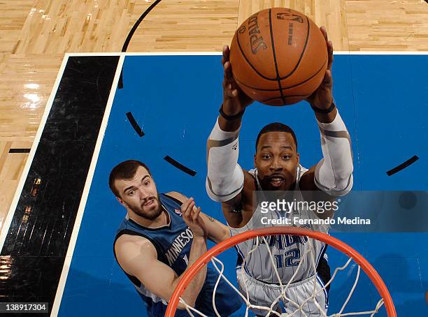 Dwight Howard of the Orlando Magic goes to the basket against Nikola Pekovic of the Minnesota Timberwolves during the game on February 13, 2012 at...