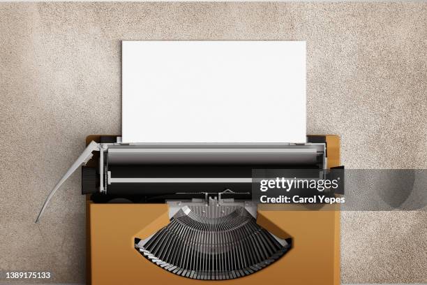 top view of a typewriter from the 70s with blank paper for text, isolated on grey background. - table font view stock pictures, royalty-free photos & images