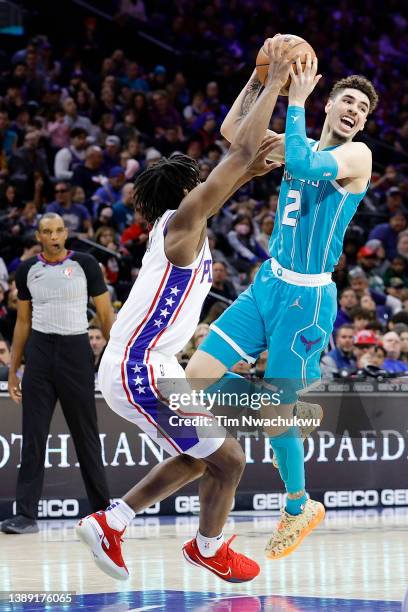 LaMelo Ball of the Charlotte Hornets tries to pass over Tyrese Maxey of the Philadelphia 76ers during the third quarter at Wells Fargo Center on...