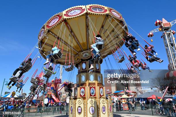 People ride on a swings at Luna Park on the opening day of the season at Coney Island on April 2, 2022 in the Brooklyn Borough of New York City. The...