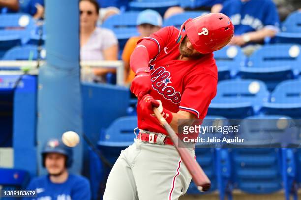 Bryce Harper of the Philadelphia Phillies hits a double in the first inning against the Toronto Blue Jays during a Grapefruit League spring training...