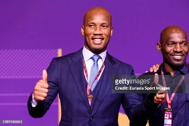 Didier Drogba and Geremi Njitap poses for photos on the red carpet prior the FIFA World Cup Qatar 2022 Final Draw at Doha Exhibition Center on April...